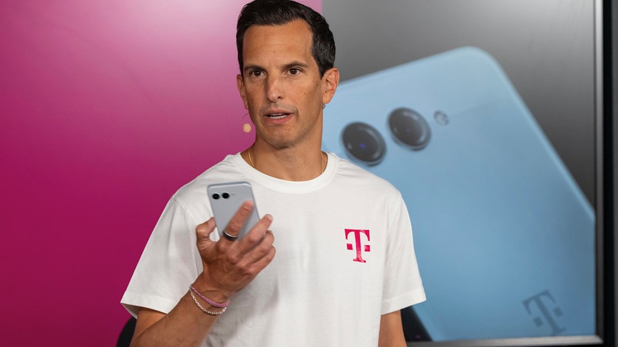 Deutsche Telekom board member and managing director at Telekom Deutschland, Rodrigo Diehl, demonstrates the telco's AI-phone. 