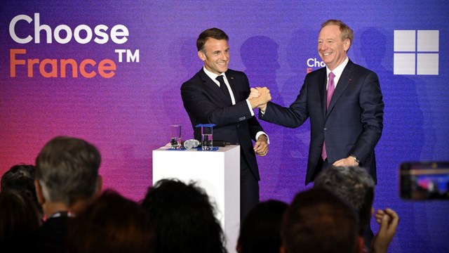 French President Emmanuel Macron looks genuinely pleased to meet Microsoft vice chairman Brad Smith at the Choose France summit.