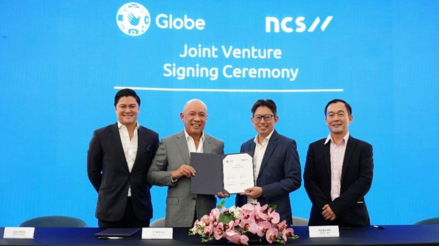 NCS and Globe executives celebrate their joint venture plans.