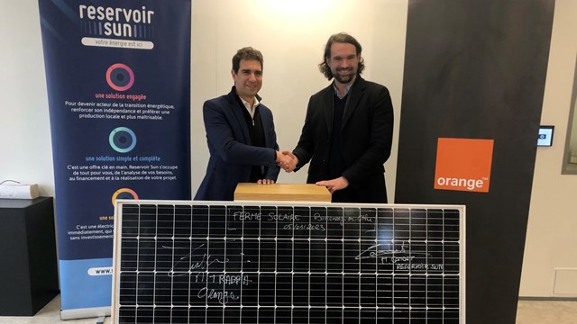 Orange's Michaël Trabbia (left) and Reservoir Sun managing director Mathieu Cambet seal their solar power deal.