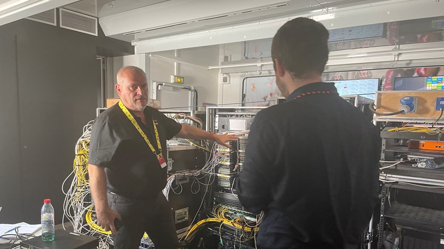 Henri Terreaux, technical team manager at Orange (on the left), presenting Orange's central hub at the Tour de France in Paris - July 2022.