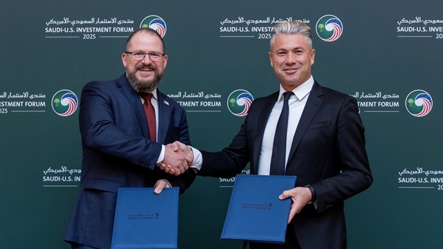 Qualcomm Technologies president and CEO Cristiano Amon (left) shakes on a deal with Humain's CEO Tareq Amin (right).