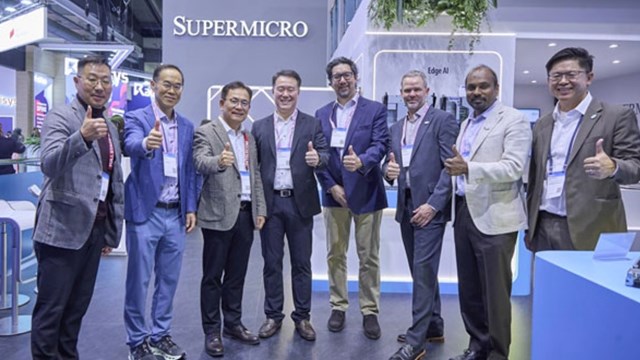 Executives from SK Telecom, Schneider Electric and Supermicro hooked up at Supermicro's MWC26 booth to celebrate the AIDC MoU.